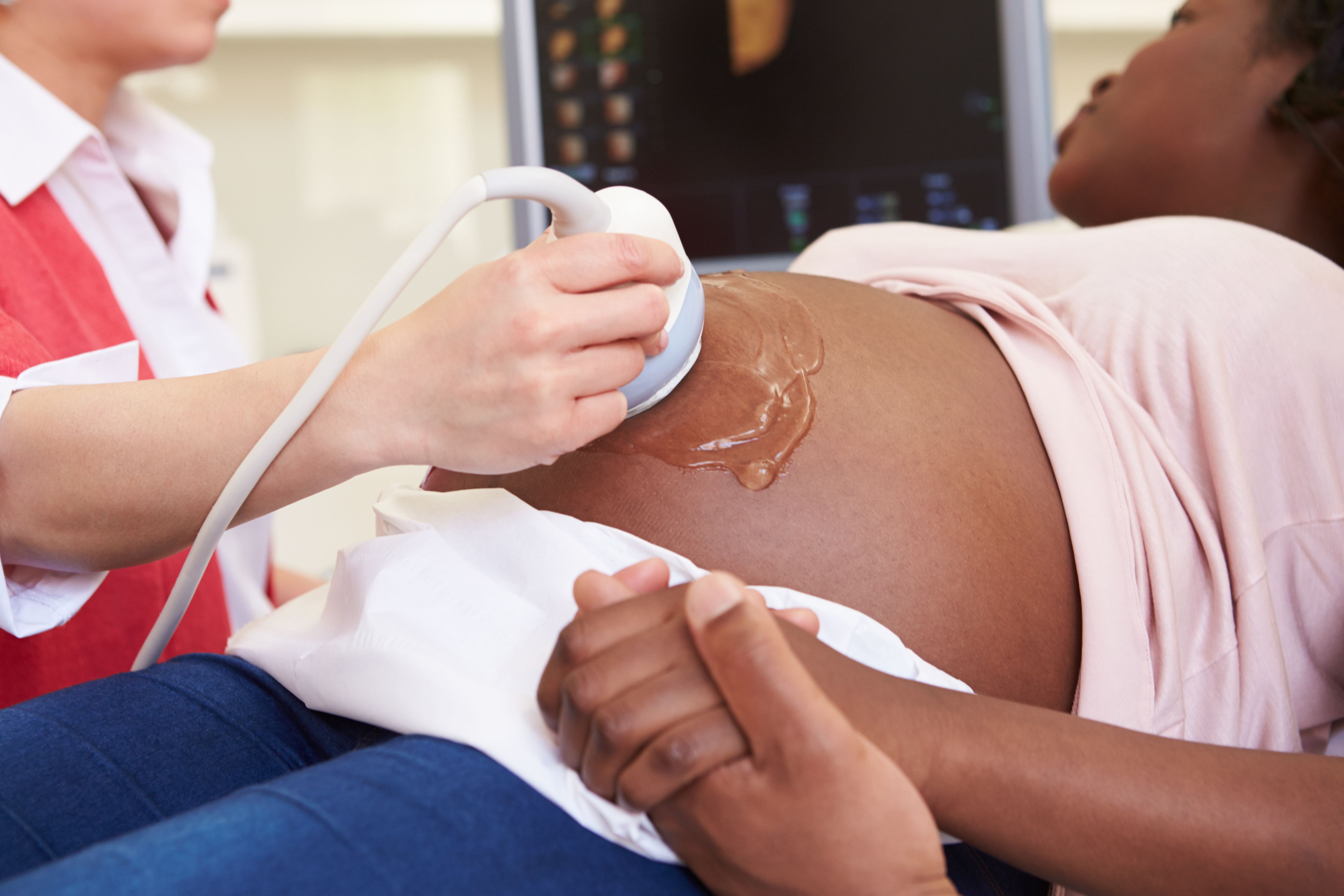 A pregnant woman having an ultrasound scan. 