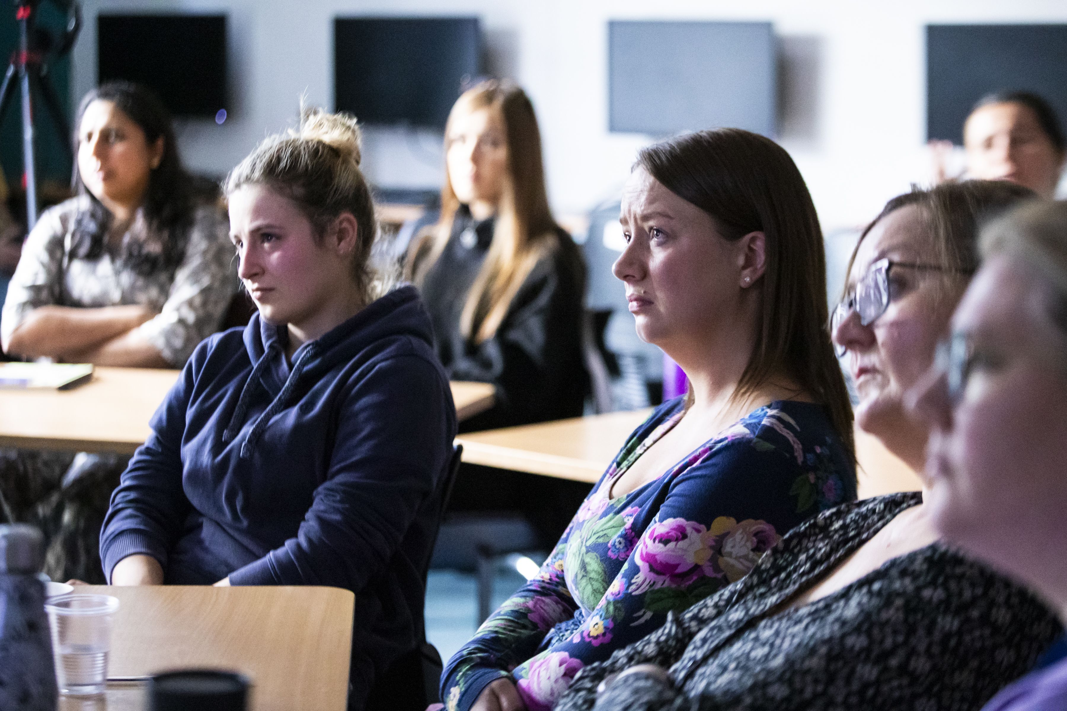 A group of healthcare professionals listening intently during a Sands Training session. 