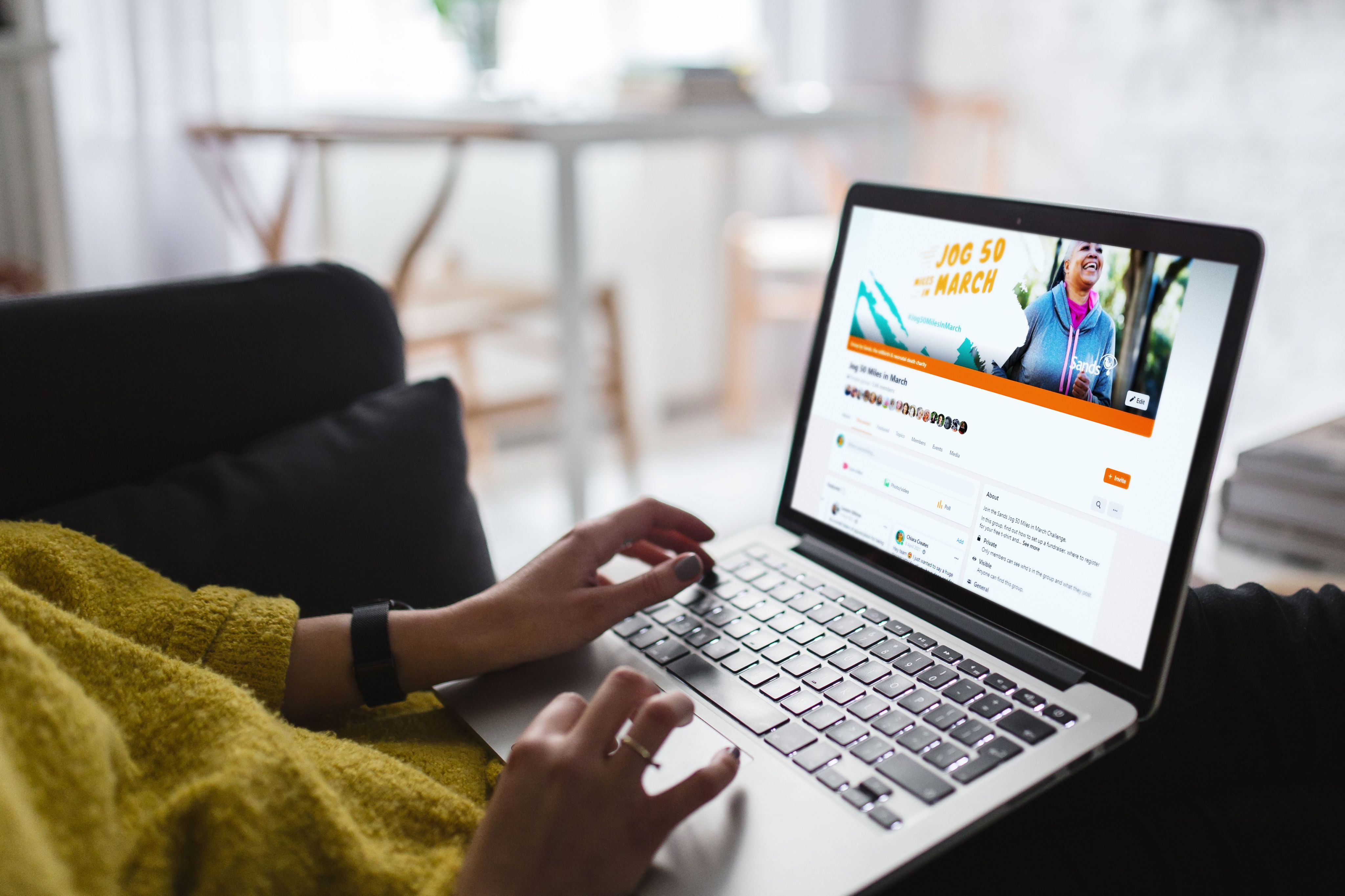 A laptop sits on a lap with on an online donation page open.
