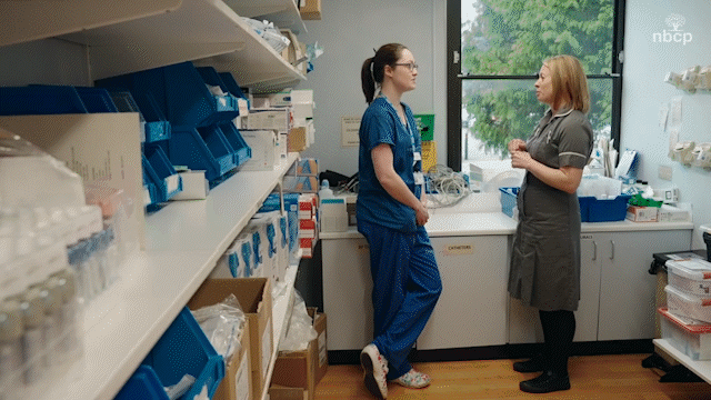 Two NHS nurses talking.