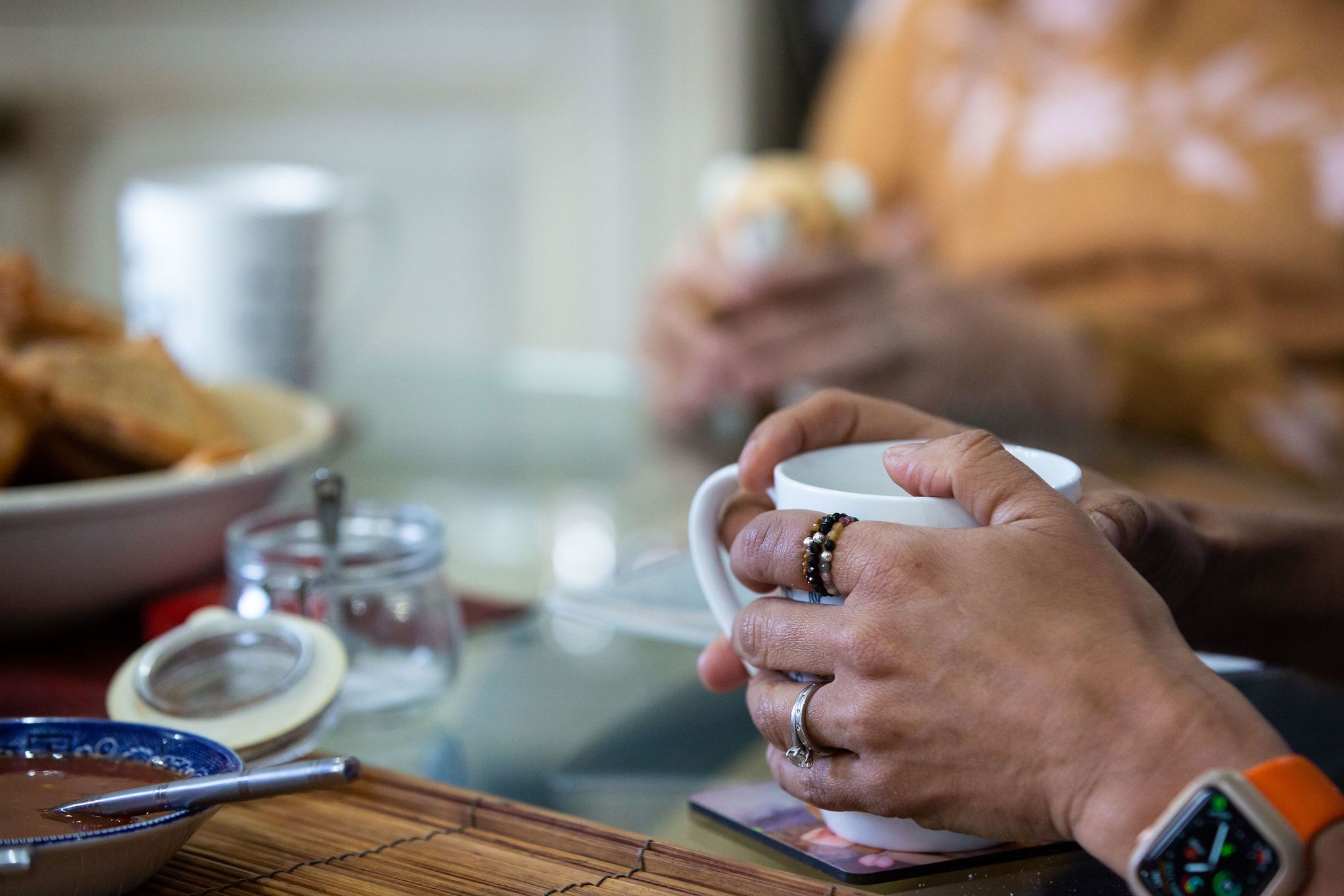 Bereaved mother holding a cup of tea.