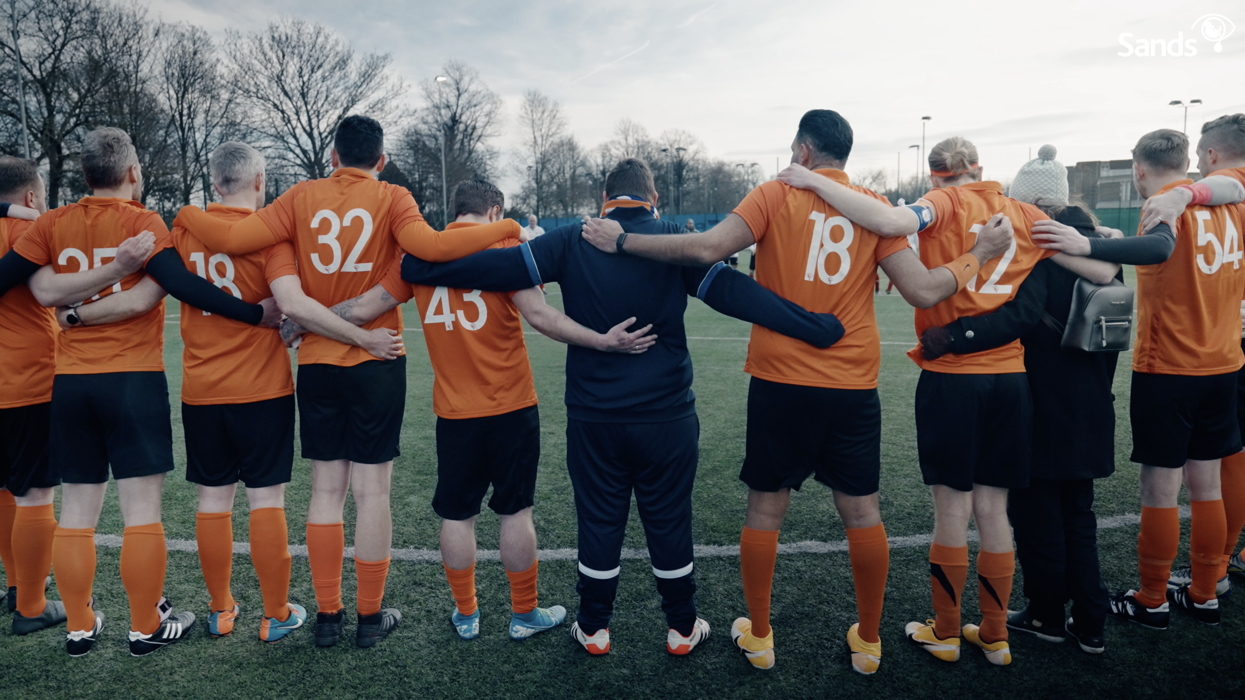 Sands United players standing together side by side with their arms around eachothers shoulders.