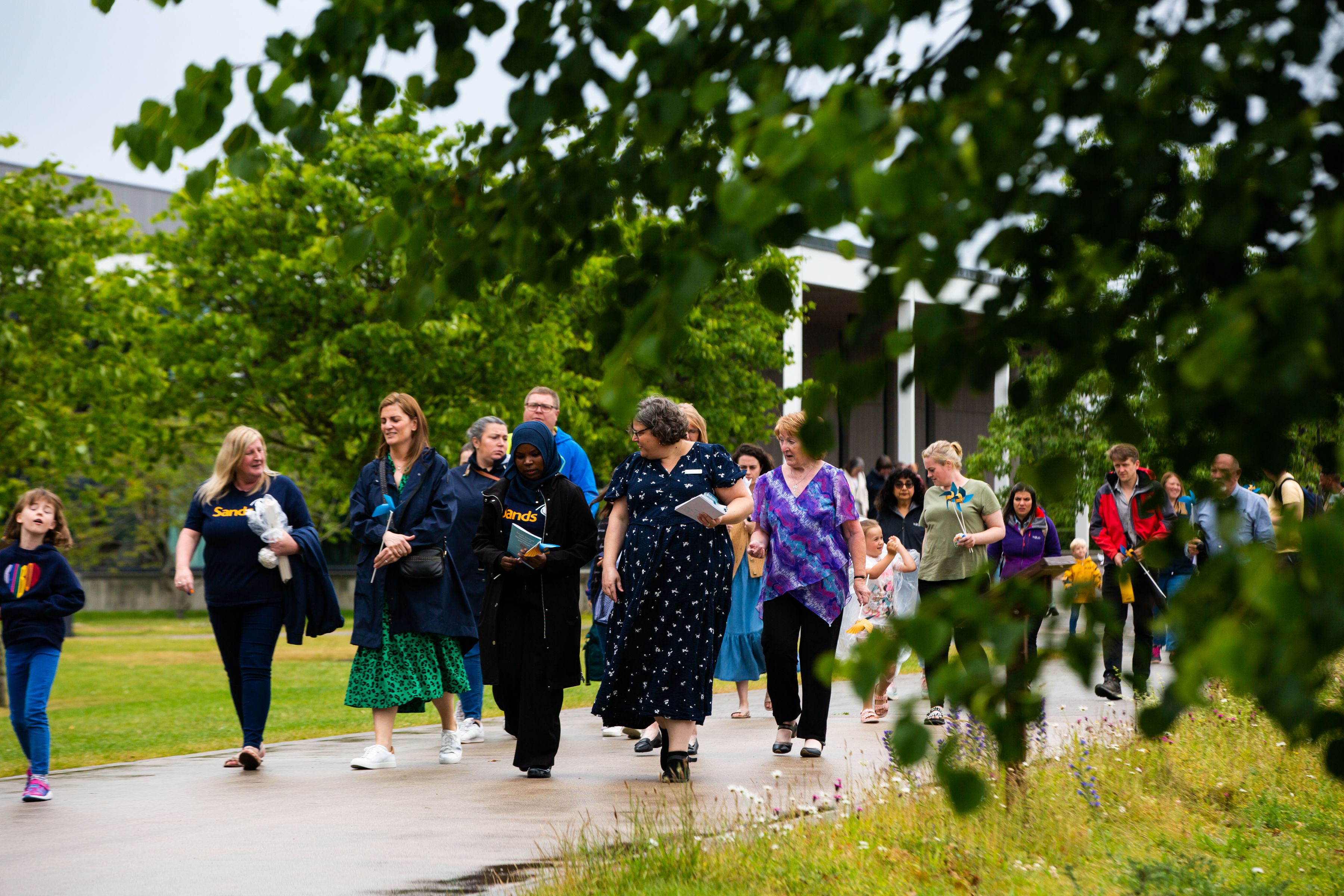 Families walking together during Sands Garden Day.