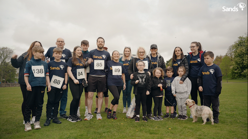 Group of Sands supporters celebrating while fundraising for Sands.