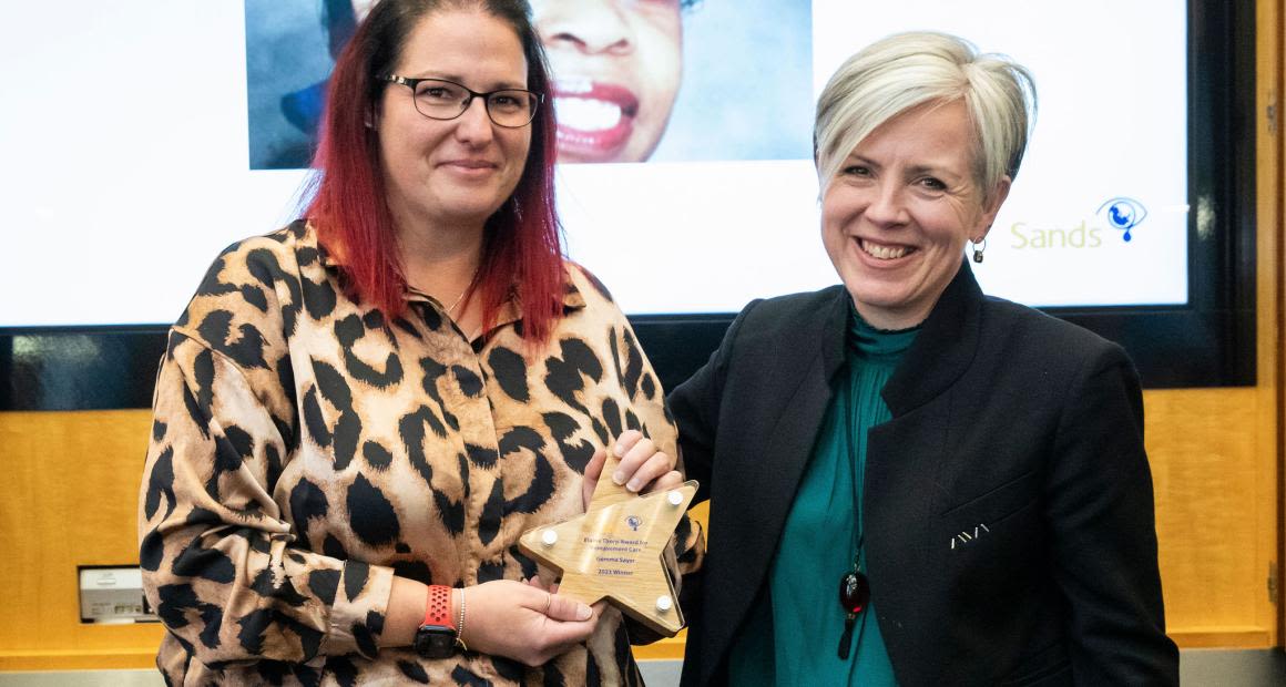 Gemma Sayer holding the Elaine Thorp Award trophy while standing next to Kate Brintworth.