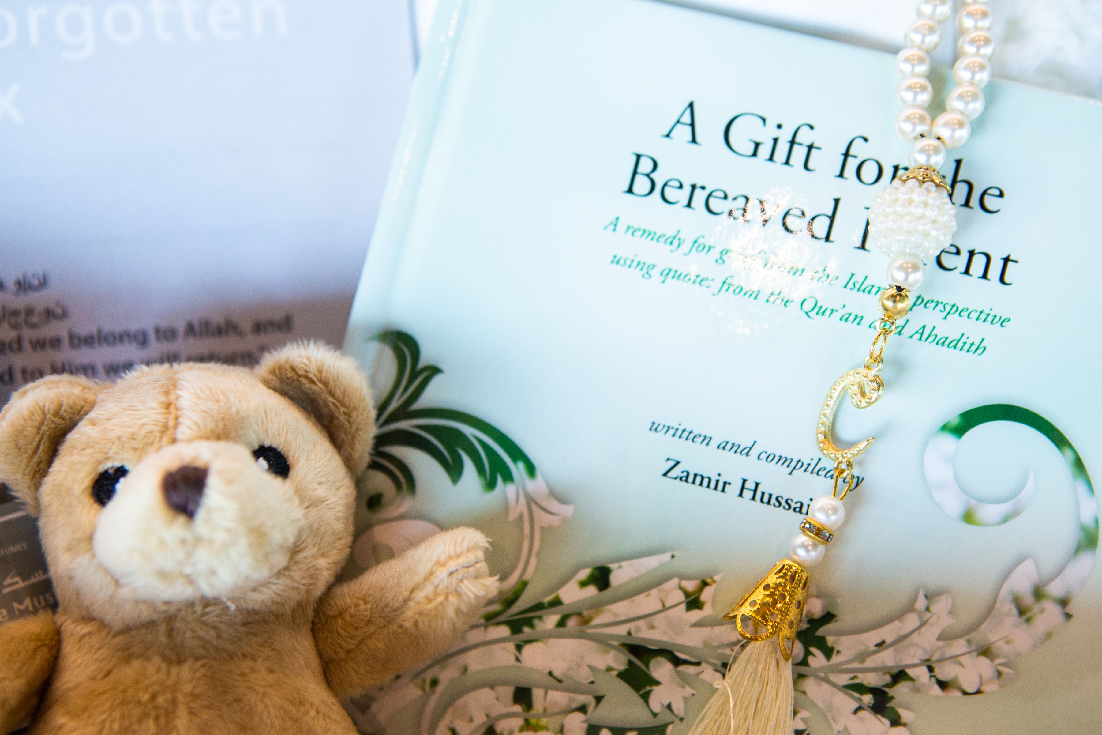Photo of the Sands Memory Box containing a Teddy Bear, Memory Box Leaflet and book titled 'A Gift for the Bereaved Parent'.