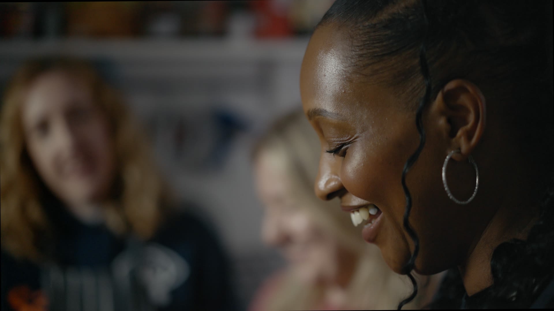 Still from the 'Become a Sands Befriender' video. Shows 3 women smiling while baking. 3 women smiling 