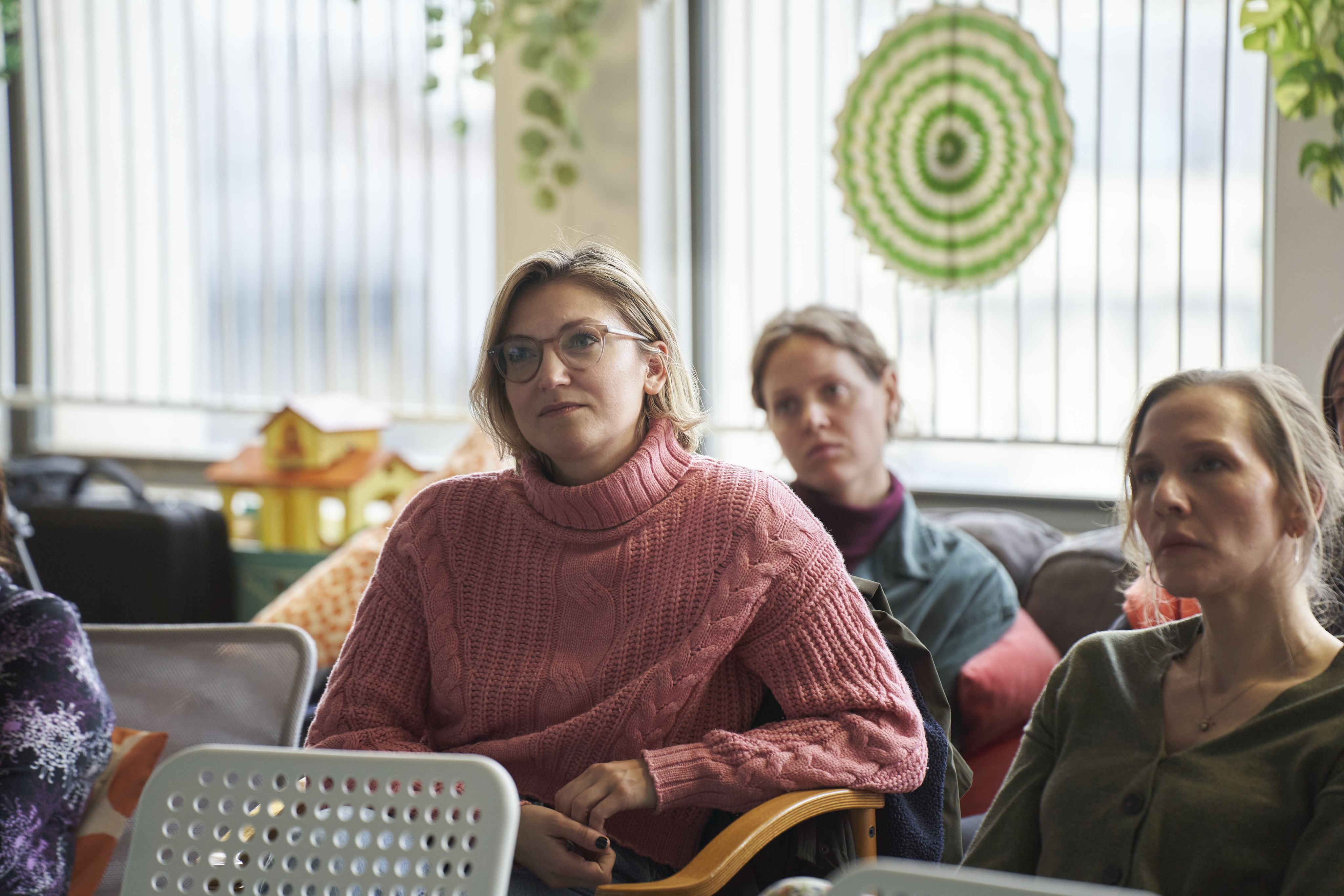 Two healthcare professionals listening during a Sands training session.